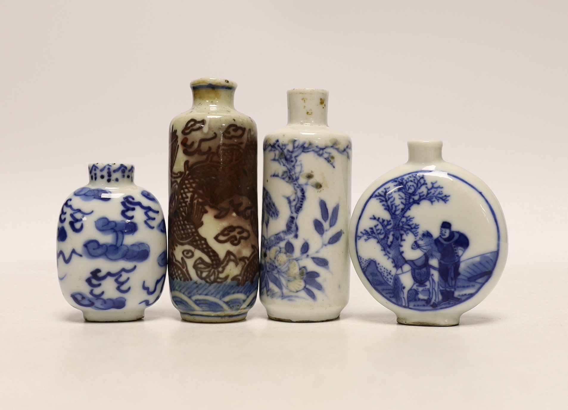 Three 19th century Chinese blue and white snuff bottles, and a similar underglaze blue and copper red Dragon snuff bottle, tallest 8cm